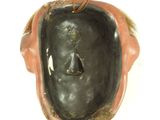 a picture of a sculpture of a man ' s face in a bowl