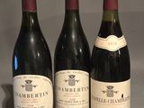 three bottles of wine are lined up on a table