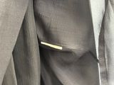 a close up of a suit hanging on a hanger
