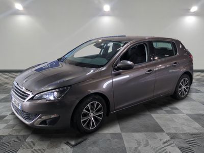 the grey car is parked on a checkered floor in the garage