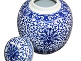 a blue and white vase and a ball on a white background