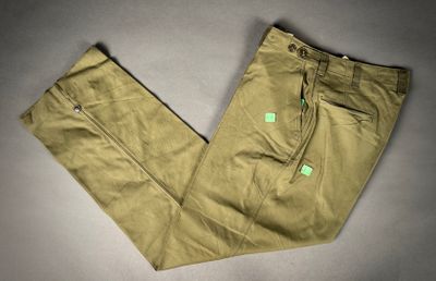 khaki pants with a green label on the side of the pants
