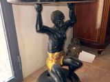 a statue of a man holding a surfboard on top of a table