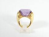 a gold ring with an amethorate stone in the center