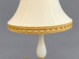 a white lamp with a gold trim and a white shade