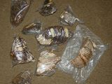 a lot of food wrapped in plastic bags on the floor