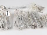 a lot of silver spoons and forks on the table