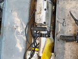 a box with a drill and other tools on the ground