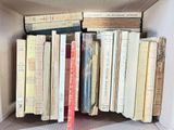 many books in a box that are stacked together