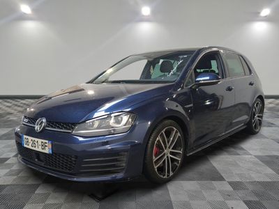 a blue volkswagen golf r - line parked in a garage