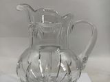 a glass pitcher sitting on top of a table