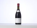 a bottle of wine sitting on top of a white table