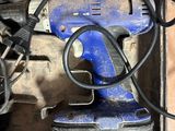 a blue corded drill sitting on top of a box