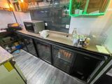 a counter with a refrigerator and a microwave in it