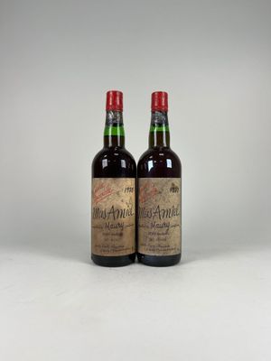 two bottles of wine sitting next to each other on a table