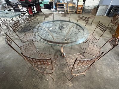 a glass table with chairs around it in a garage
