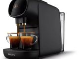 a close up of a coffee machine with two cups of coffee