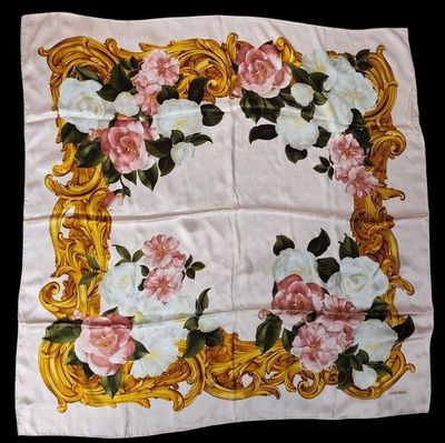an image of a white and pink flowered scarf on a black background