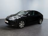 the black tesla model x is parked in a white room