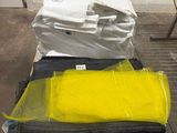 yellow and black luggage sitting on top of a pallet in a warehouse