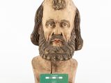 statue of a man with a beard and a green card in front of him