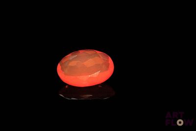 an image of a glowing orange stone on a black surface