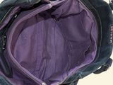 a black purse with a purple lining on it