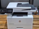 a white printer sitting on top of a wooden table