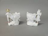 pair of white porcelain figurines of a man and a woman