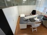 an image of an office cubicle with a desk and a chair
