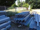 a pile of steel beams sitting in the grass