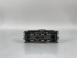 a close up of a small black train engine on a white surface