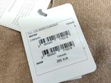 a label on the back of a sweater that is attached to a hanger