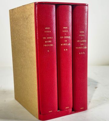 three red books sitting on top of each other on a table