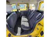 the interior of a yellow car with black seats and black trims