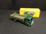 a toy truck that is sitting next to a box