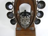 a wooden clock with a black and white design on it