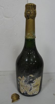 a bottle of wine that has been left on the table
