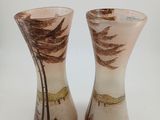two vases that are sitting on a white surface