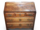 an old wooden chest of drawers with brass hardware on the drawers