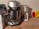 a mixer on a wooden shelf next to a blender