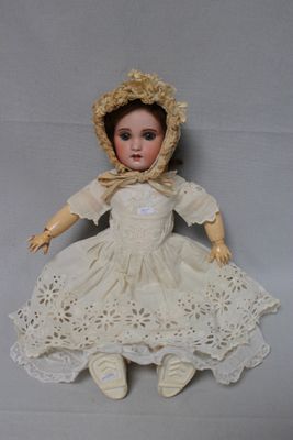 a doll that is sitting on a white surface