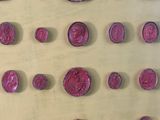 a lot of red wax seals on a yellow surface