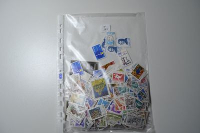 a bag full of stamps on a white surface