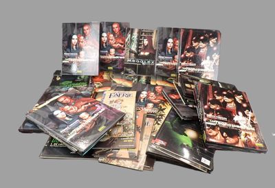 a lot of dvds that are stacked on top of each other