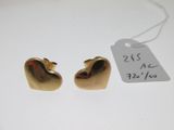 pair of gold heart shaped earrings on white background with price tag