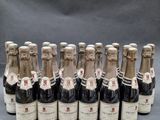six bottles of wine are lined up in a row on a table