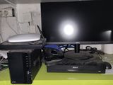 a computer desk with a monitor, keyboard, mouse, and other electronics on it
