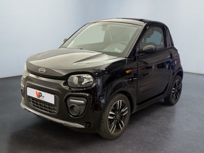 a picture of a small black car parked in a room