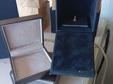 a box with a ring inside of it sitting on a table